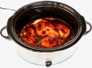 Cranberry chicken in slow cooker.