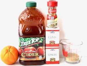 Spiced Apple Cider ingredients including cloves, ginger, and cinnamon sticks.