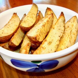 Blue and white bowl of potato wedges.