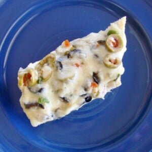 Slice of olive bread on plate.