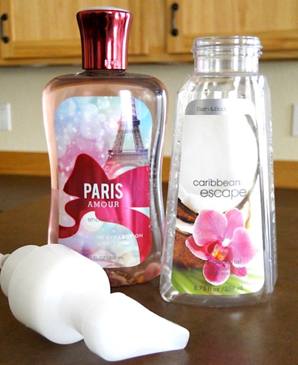 Bottle of body wash next to empty foaming soap container.