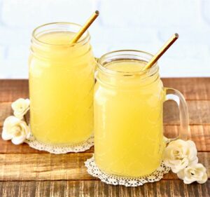 Two jars of yellow party punch.