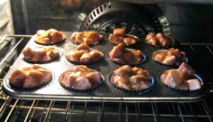 Monkey Bread Muffins in a pan in the oven.