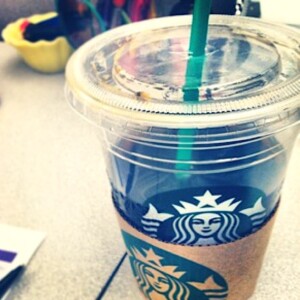 Starbucks cup with a straw.