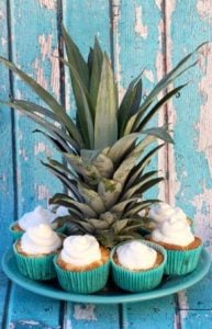 Pineapple Angel Food Cupcakes around a pineapple top.