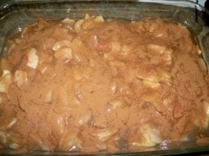 Apple pie filling topped with seasonings.