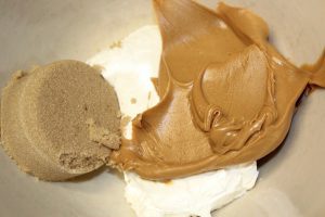 Cool Whip, peanut butter, and brown sugar in a bowl.