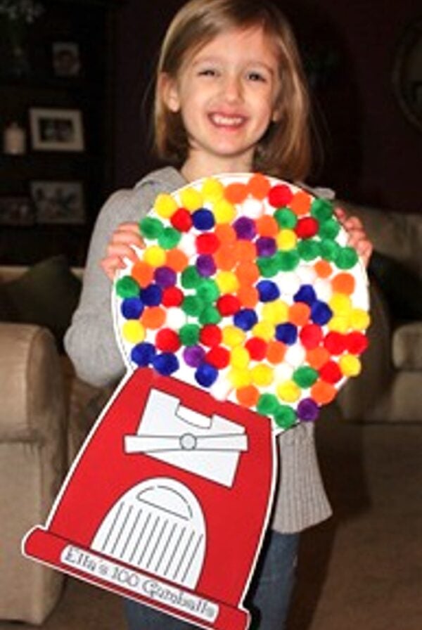 Child holding 100th day of school gumball project.
