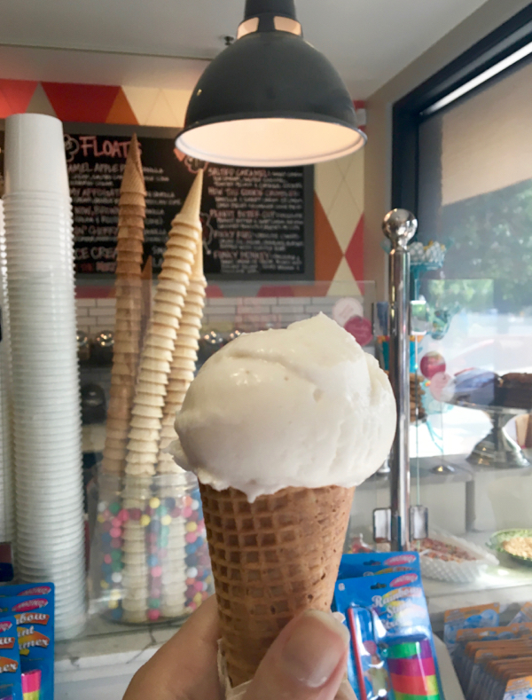 Ice cream cone being held in hand.