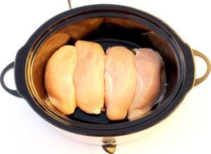 Chicken breasts in a slow cooker.