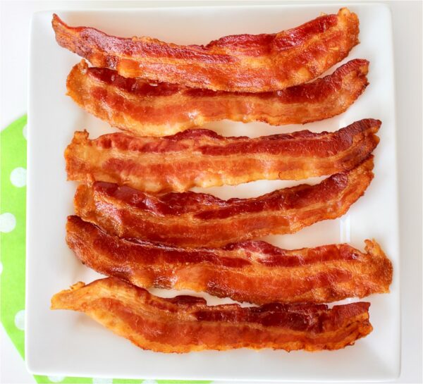 Cooked bacon on a plate.