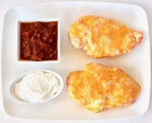 Salsa Chicken on a plate with salsa and cream cheese.