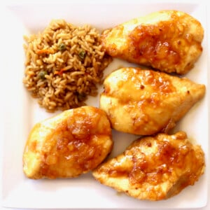Mandarin chicken on a plate with brown rice.