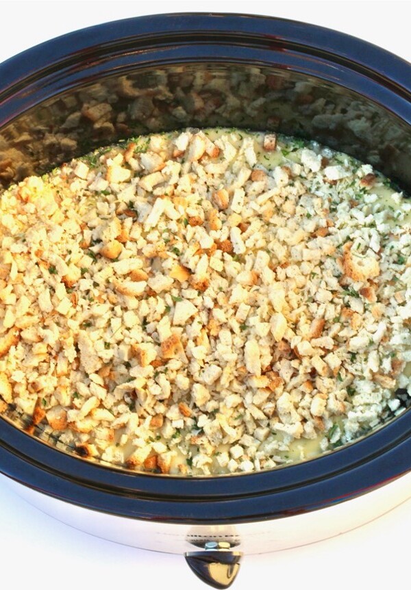 Stuffing over chicken in a slow cooker.