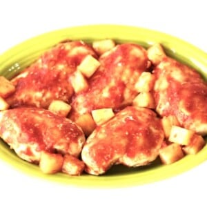 Hawaiian Chicken with pineapple chunks on a yellow plate.