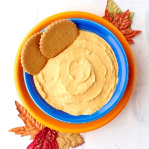 Pumpkin dip in blue bowl with gingersnaps.