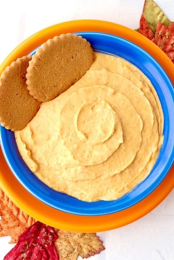Pumpkin dip in blue bowl with gingersnaps.