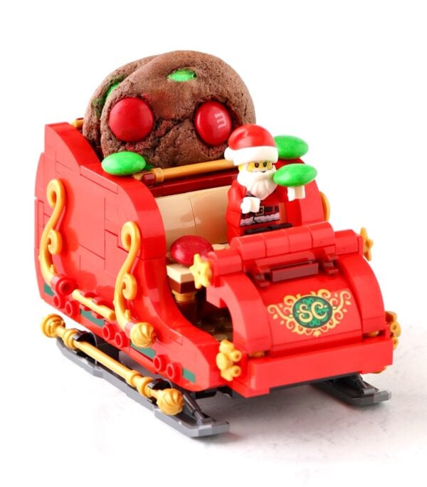 Chocolate M&M Christmas cookies in Santa\'s Lego sleigh.