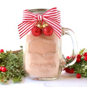 Homemade Hot Chocolate Mix packaged in mason jar mug with lid and bow.