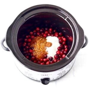 Cranberry sauce ingredients unmixed in crockpot.