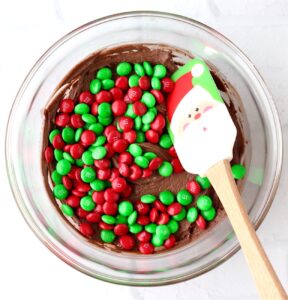 Chocolate cookie dough with Christmas M&Ms and Santa spatula.