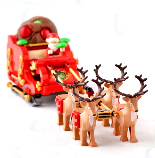 M&M Christmas cookies in Santa\'s Lego sleigh being pulled by reindeer.