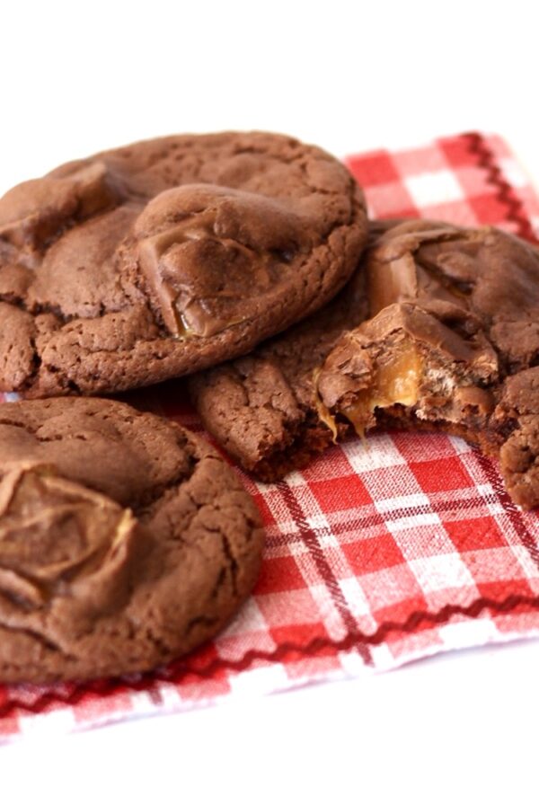 Three chocolate Milky Way cookies on napkin.