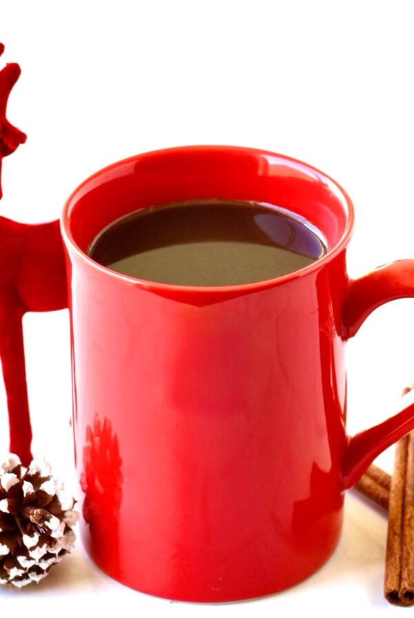Cinnamon coffee in a red mug with a pinecone.