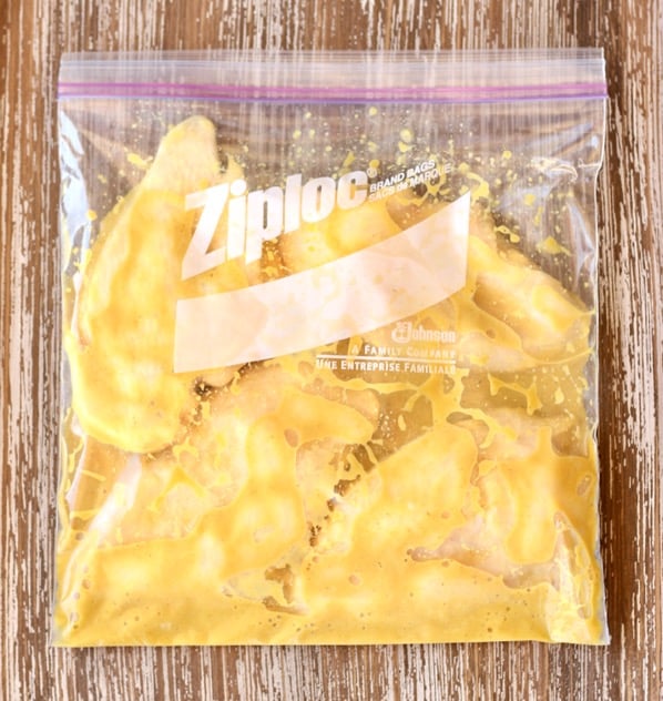 Chicken breasts with honey mustard sauce marinating in freezer ziploc bag.