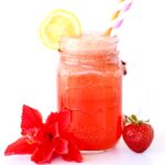 Straw in a jar of strawberry lemonade punch.