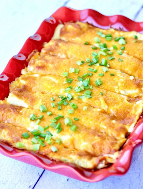 Chicken Enchiladas in a red baking dish.
