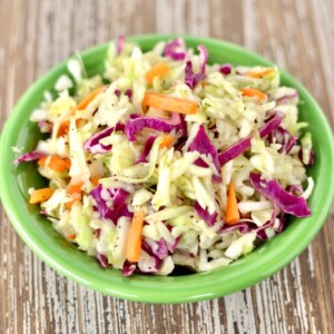 Sweet and Sour Coleslaw in a green bowl.