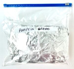 Foil-wrapped pumpkin bread in a freezer bag.