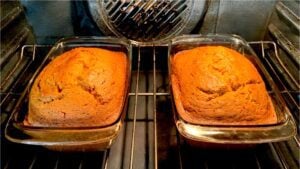Two pans of pumpkin bread in the oven.