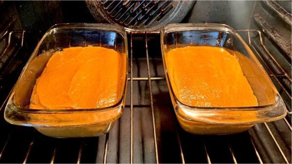 Pans of bread batter in the oven.