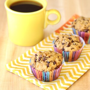 Pumpkin Spice Chocolate Chip Muffins with a mug of coffee.