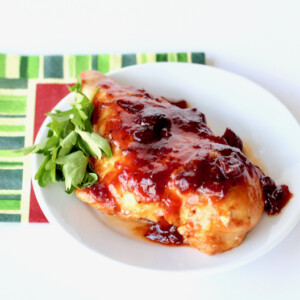 Baked Cranberry Orange Chicken on a white plate.