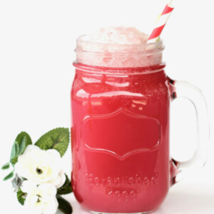 Sparkling Cranberry Party Punch in a jar with a straw.