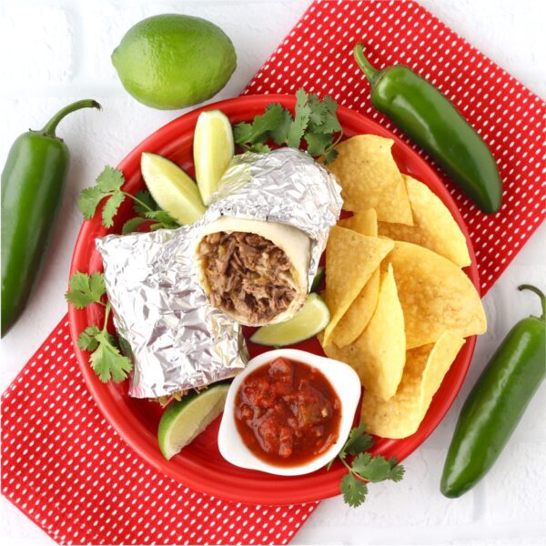 Chips and a burrito on a red plate.