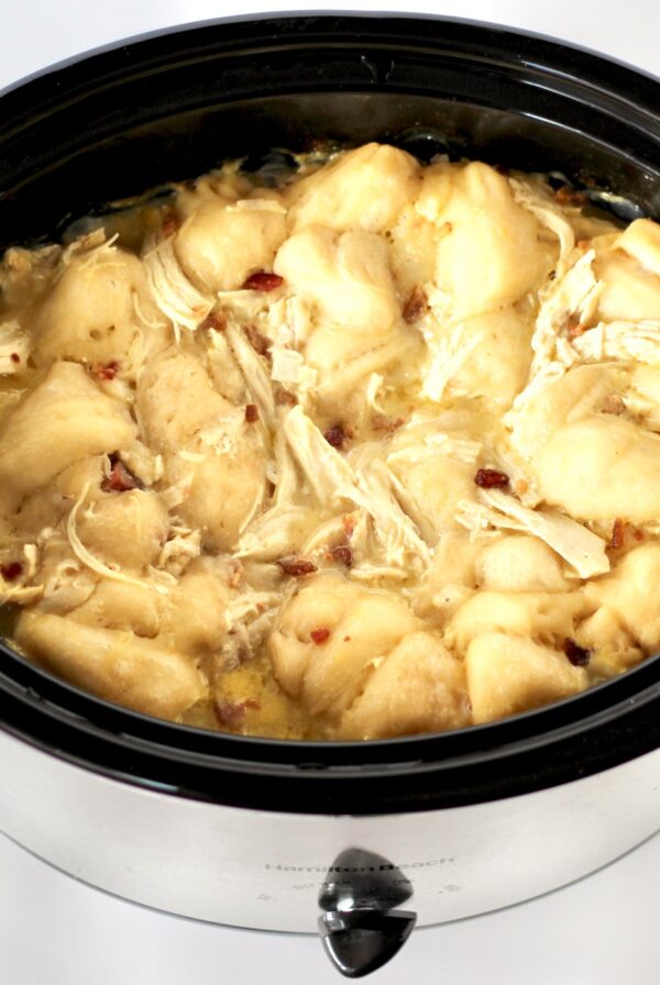 Chicken and dumplings with biscuits in a slow cooker.