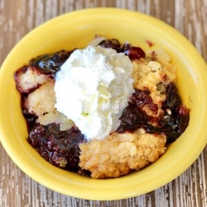 Blackberry Dump Cake in a yellow bowl.