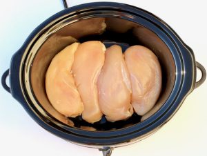 Chicken breasts in a slow cooker.