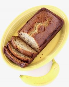 Partially-sliced loaf of banana bread.
