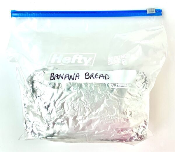 Foil-wrapped bread in a bag labeled \"Banana Bread.\"