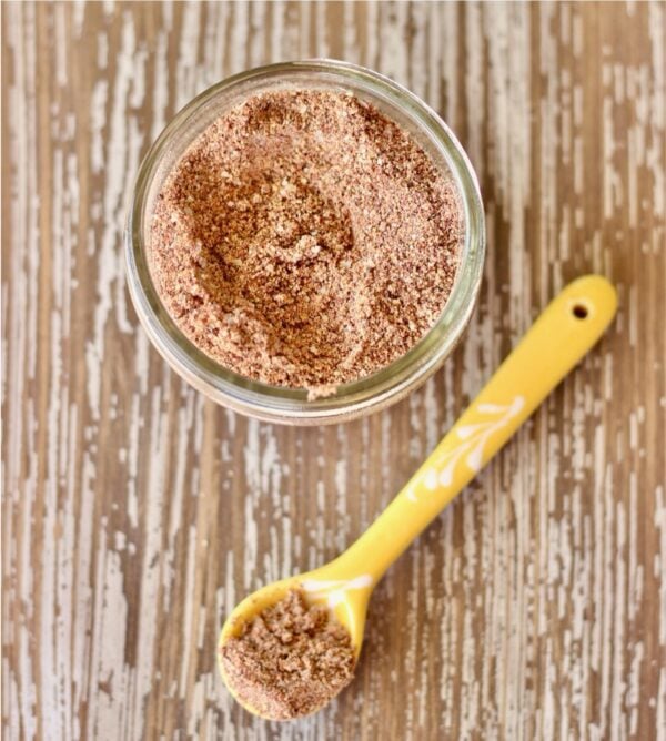 Taco Seasoning on a spoon and in a jar.