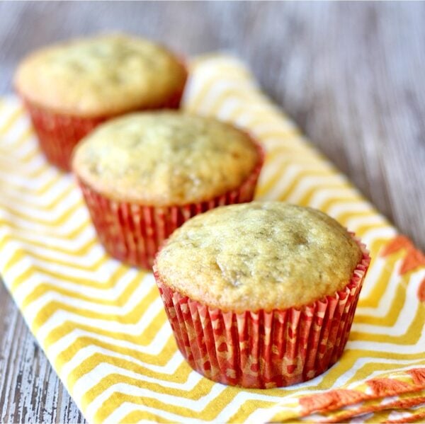Three banana bread muffins on napkin.