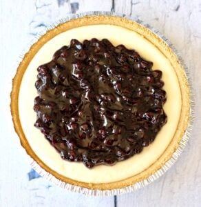Blueberry filling over a cream cheese pie.