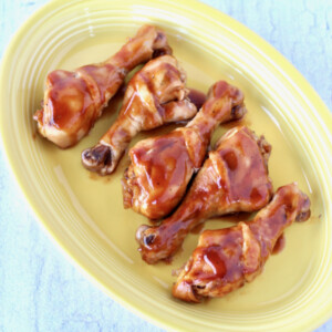 Barbecue Coke Drumsticks on a yellow platter.