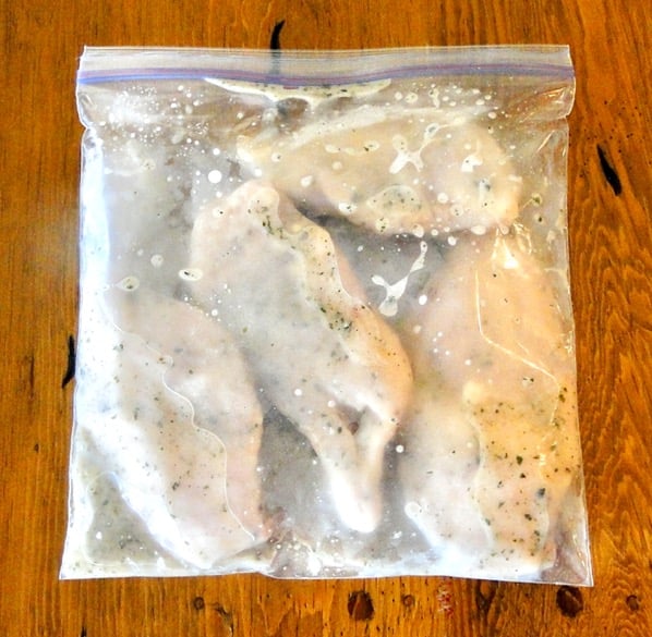 Chicken marinating in ziplock bag.