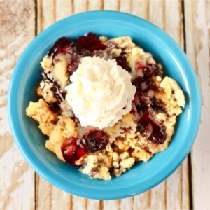 Blueberry dump cake in a blue bowl.